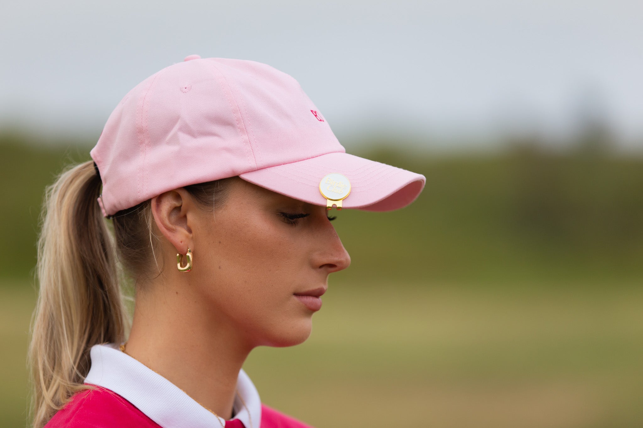 Birdie Club womens golf cap in pink with embroidered logo, side view.