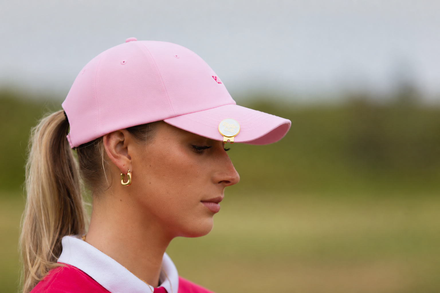 Birdie Club womens golf cap in pink with embroidered logo, side view.