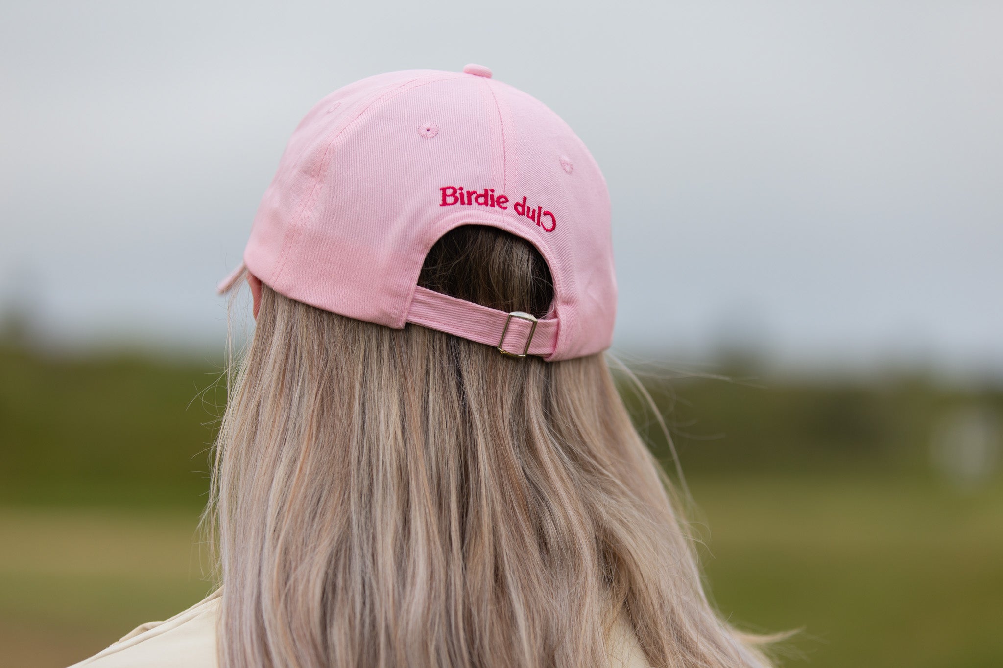 Birdie Club womens golf cap in pink with embroidered logo, back view.