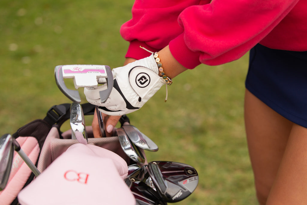 Birdie Club womens golf score counter bracelet with gold plating, in action.
